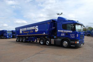 Logistics BusinessRoger Warnes Transport, the Norfolk (UK)-based bulk haulage specialist, has selected a package of TruTac fleet management software tools to ensure the highest level of compliance and efficient control of its 90-strong mixed vehicle fleet.
<br></noscript><br>
Operating throughout the UK from depots in Great Dunham and Kings Lynn, the company provides a diverse range of bulk transport services, using a mix of articulated and rigid tippers and walking-floor vehicles.
<br><br>
Following a recent due diligence review and as members of FORS (Fleet Operator Recognition Scheme) Roger Warnes Transport installed TruTacs TruControl and TruLicence systems to manage tachograph analysis and driver licence checks – the combination of which provides the company with guaranteed compliance and helps to ensure best practice across the fleet.
<br><br>
For tachograph analysis, TruControl is a fully secure, web-based system which provides automated exception-based reporting across multiple depots. Reports can be prepared instantly and emailed to any transport manager or multiple users to suit any fleet size and it is fully compliant with the hours law and WTD (Working Time Directive).
<br><br>
To reduce administration and to help Roger Warnes Transport demonstrate a duty of care towards its drivers, TruLicence is an online checking and validation service which protects against employees driving without a valid licence. The unique application also guards against potential litigation in the event of accidents where a drivers licence is found to be invalid.
<br><br>
Roger Warnes Transport is a VOSA-approved ATF (Authorised Testing Facility) incorporating a tachograph calibration centre and test facilities for HGV and PSV vehicles. The company is also a bulk storage specialist with the facility to store 20,000 tonnes of grain, oil seed and sugar beet pulp, using computerised stock control. Furthermore, automated grain sampling and temperature monitoring throughout, combine to achieve TASCC (Trade Assurance Scheme for Combinable Crops) standards.