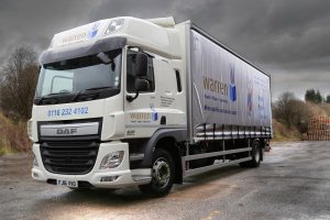 Logistics BusinessWarren, a UK carton and graphical board and paper stockist, has responded to the twin challenges of significant sales growth and the changing nature of the UKs independent haulage sector by taking delivery of its first Warren-branded vehicles. 
<br></noscript><br>
The new DAF CF curtain-sided 18 and 26T rigids have been taken on long-term rental from local truck supplier Alltruck plc and are liveried with the unmistakable Warren branding that includes Warrens distinctive rabbit mascot, Starsky. 
<br><br>
Operations Director, David Whitaker, explains, <i>From day one, forty years ago, we were known as a national rather than a regional merchant. Own-vehicle operation was impractical and instead we partnered successfully with a number of independent hauliers throughout the UK to provide customers with the service they required. In recent years a combination of factors has contributed to the fragmentation of national haulage. Very few hauliers provide national groupage services these days and depend instead on pallet networks, which dont always suit our products or – more importantly – our customers.
</i><br><br>
As an ISO14001 certified company, Warren takes its environmental responsibilities seriously. <i>Given the current controversy surrounding diesel emissions it was essential that we operated new, rather than second-hand, trucks, </i>commented Dave Whitaker. <i>Both are Euro6 compliant so meet the latest and most stringent emissions regulations and we do our best to ensure that the vehicles are loaded and routed for maximum efficiency.</i>
<br><br>
The decision to develop its own transport operation in the Midlands followed the introduction late last year of Warrens logistics partnership agreement with North-East based Tyneside Express. Warren trunks overnight to Tyneside in order to provide its expanding paper and board customer base in the North East region with an improved next-day service and Warrens operations team see this as a model that theyre likely to replicate in other parts of the country over the coming months.